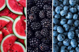 Slices of watermelon, blackberries, and blueberries are arranged side by side
