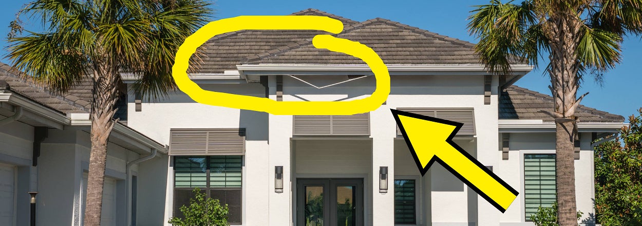 Modern home exterior with palm trees, highlighting a yellow arrow pointing at a section of the roofline detail