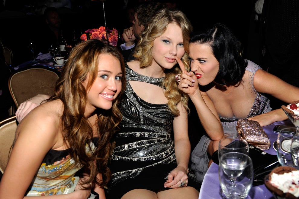24 Bizarre Celeb Facts That Sound Fake, But Are 100% True 10 Three celebrities pose playfully at a formal event, wearing glamorous dresses with metallic and sparkling details, smiling and enjoying the moment