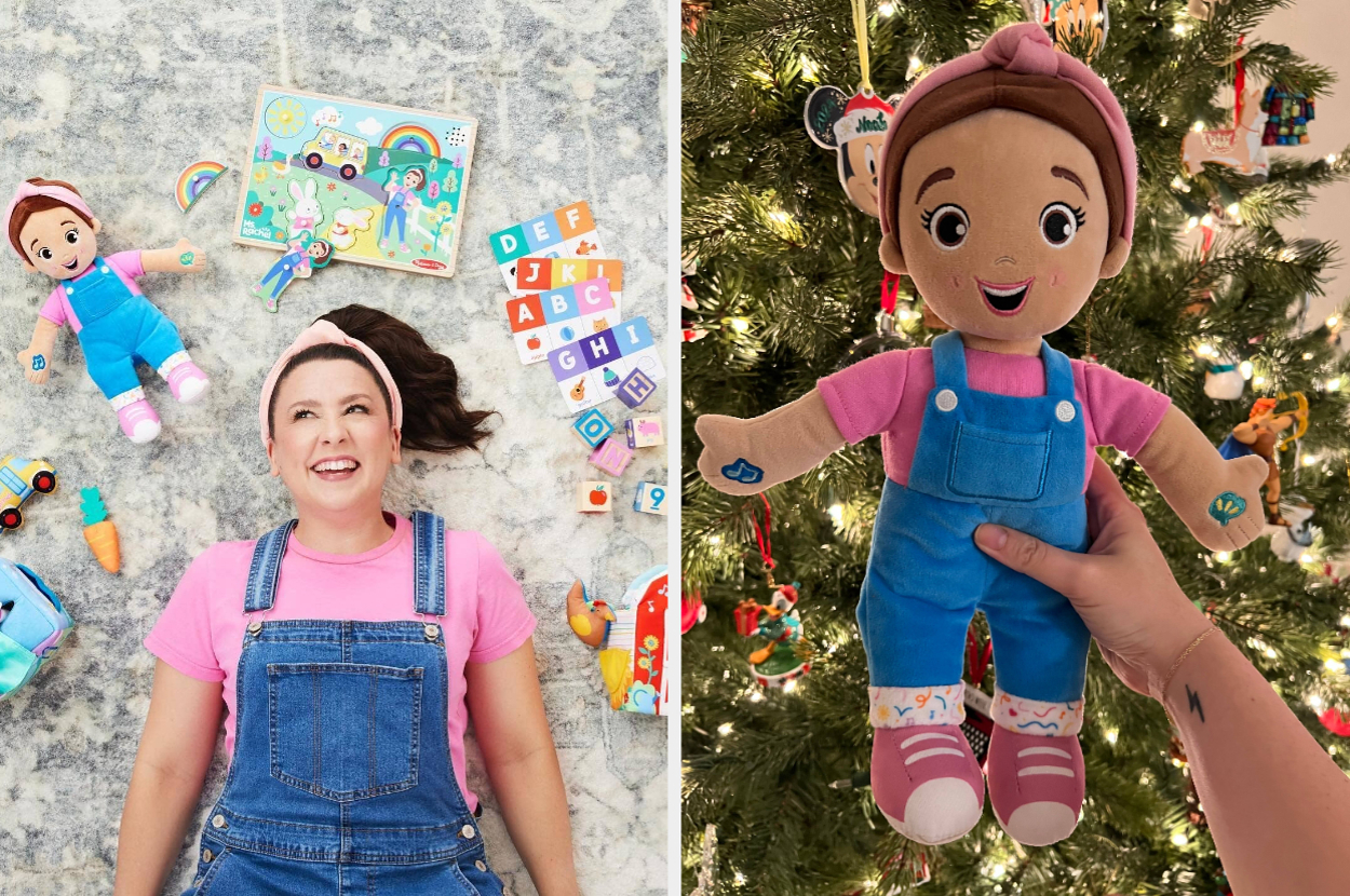 Person wearing overalls and pink shirt on rug with toys; Holding a matching doll in front of a Christmas tree. Suitable for children's gifts