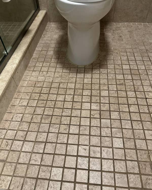 Bathroom floor tiles cleaned with baking soda, hydrogen peroxide, and dish soap. Shows improved appearance