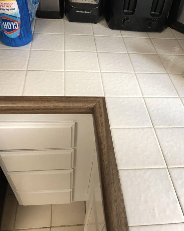 Reddit image showing a home renovation post about replacing a wine cellar cover. The cover should be flush with the tile floor