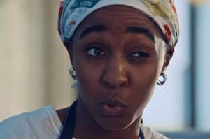 Person with a kitchen headscarf making a playful expression, suggesting a lively cooking atmosphere