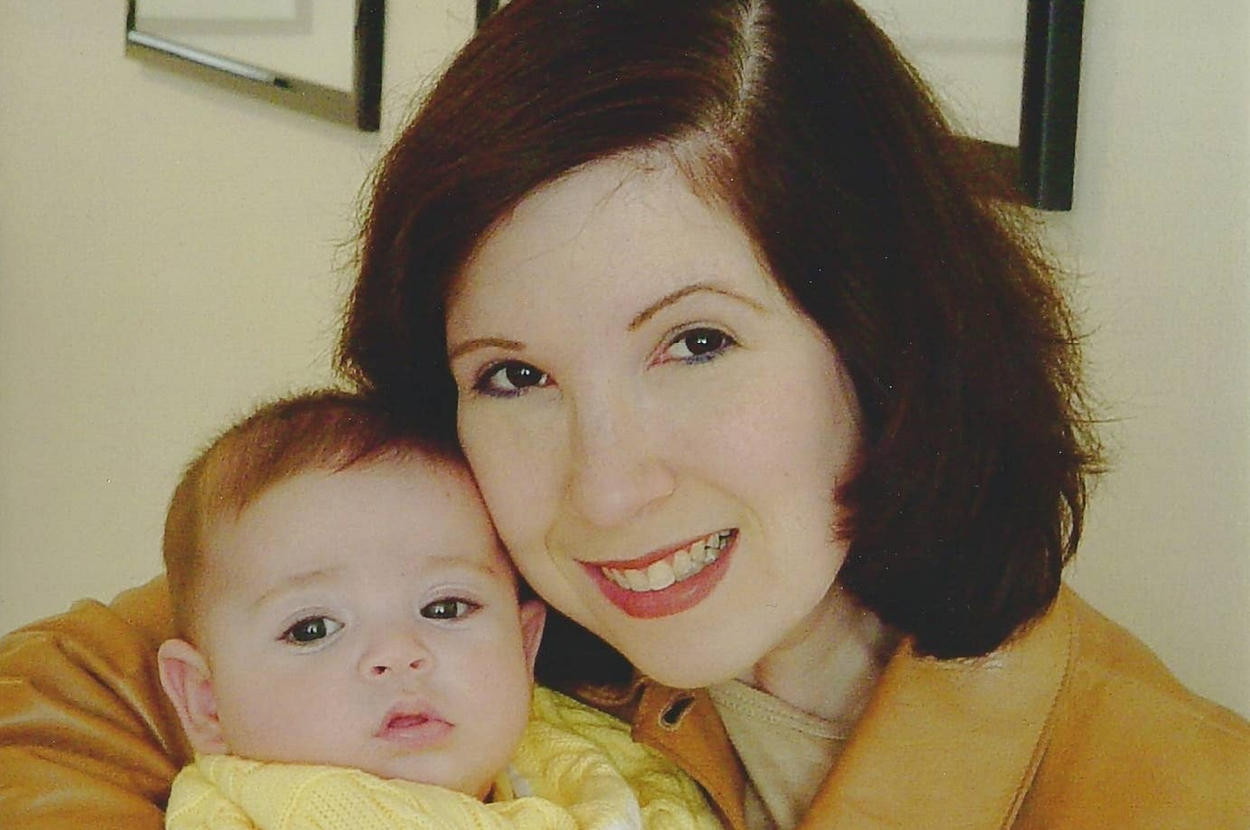 The author poses with her baby