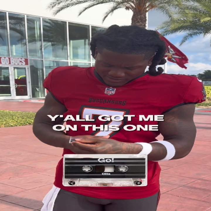 Football player in a practice uniform holding a phone, with text overlay: "Y'all got me on this one."