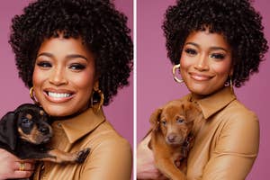Person in a sleek tan outfit smiles while holding two different puppies against a plain backdrop