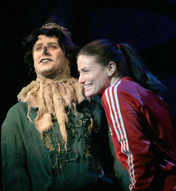 Joey McIntyre as the scarecrow and Idina Menzel in a red tracksuit performing in Wicked