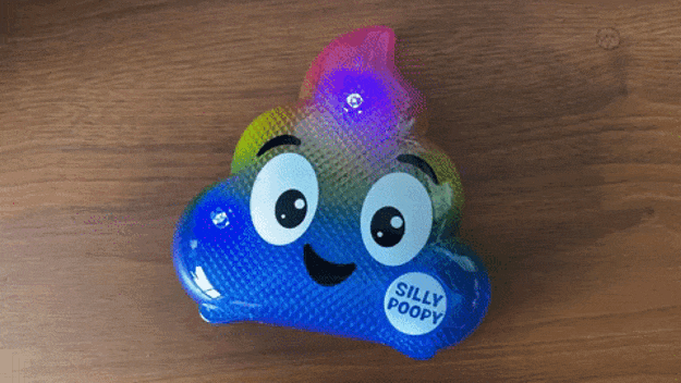 A dancing artifact shaped similar a poop emoji with a smiling look and the substance