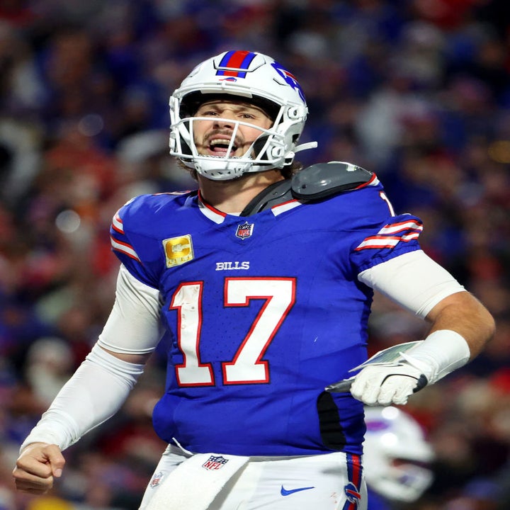 Football player in uniform, wearing a helmet and number 17 jersey, celebrating during a game on the field