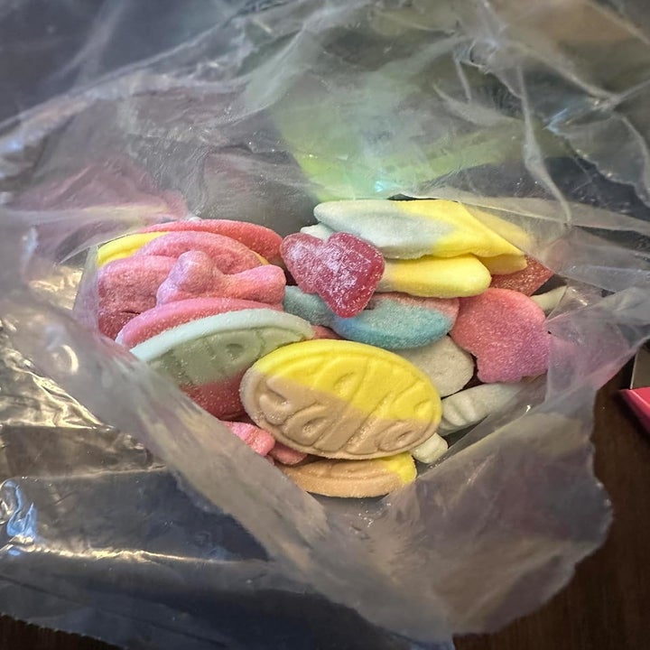 A bag of colorful, assorted gummy candies in various shapes and designs