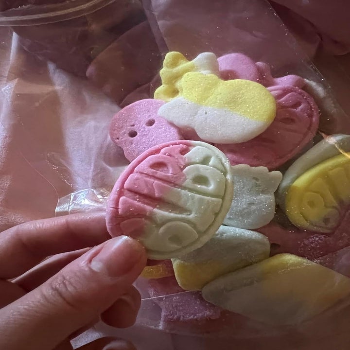Hand holding pastel, embossed marshmallow candy