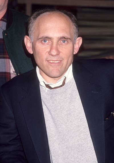 Armin in a suit jacket and sweater, smiling at a public event