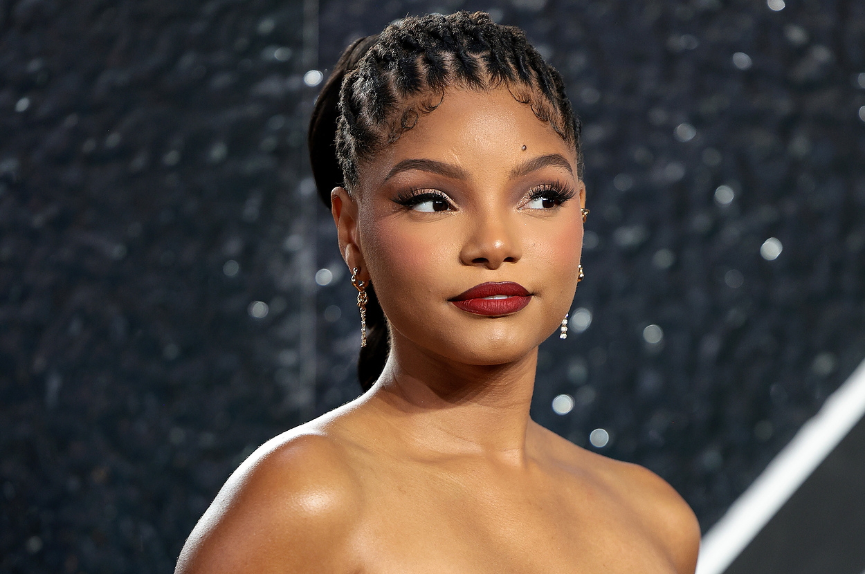 Halle Bailey in elegant strapless dress with braided hairstyle poses at a formal event