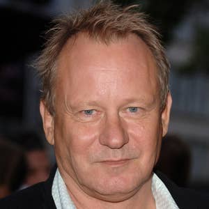 Stellan in a casual open-collar shirt and jacket at an event, posing for a photo