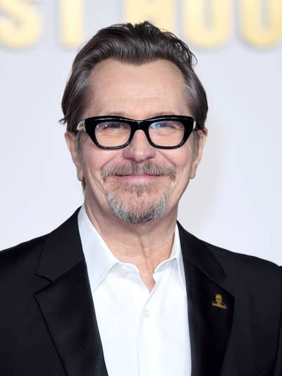 Gary in a suit with glasses, smiling at an event