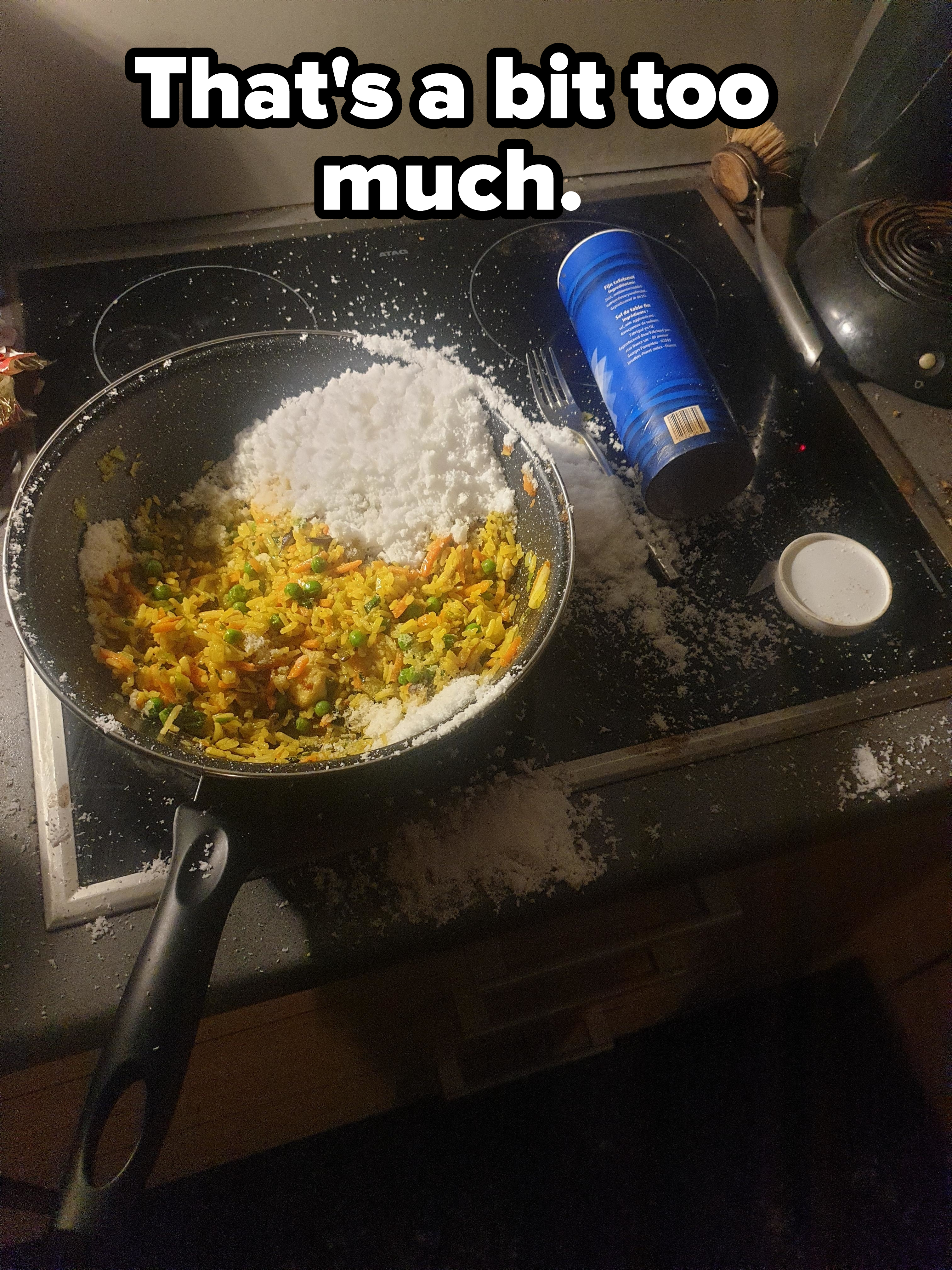 Frying pan with fried rice accidentally covered in spilled flour on a stovetop