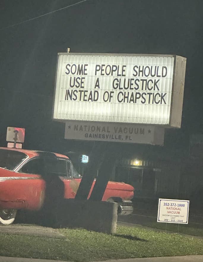 A humorous sign reads: "Some people should use a glue stick instead of chapstick." A vintage car is parked below the sign