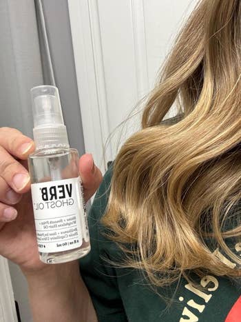 Reviewer holding the spray