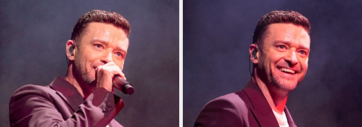 A man on stage sings into a microphone, wearing a stylish suit jacket over a casual shirt