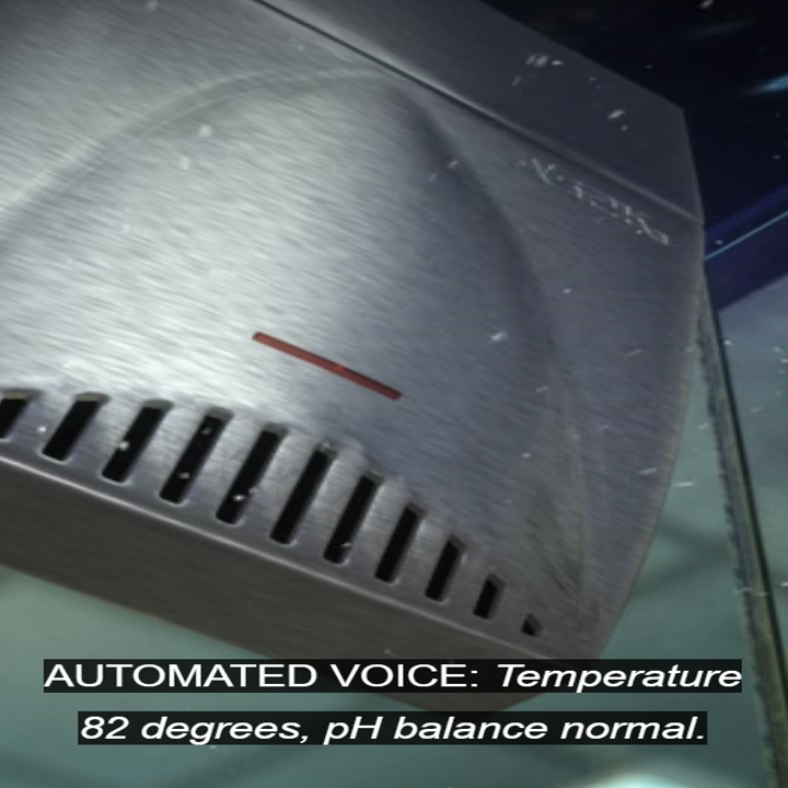 A sleek, silver automated device with a voice output displays temperature as 82 degrees and confirms normal pH balance