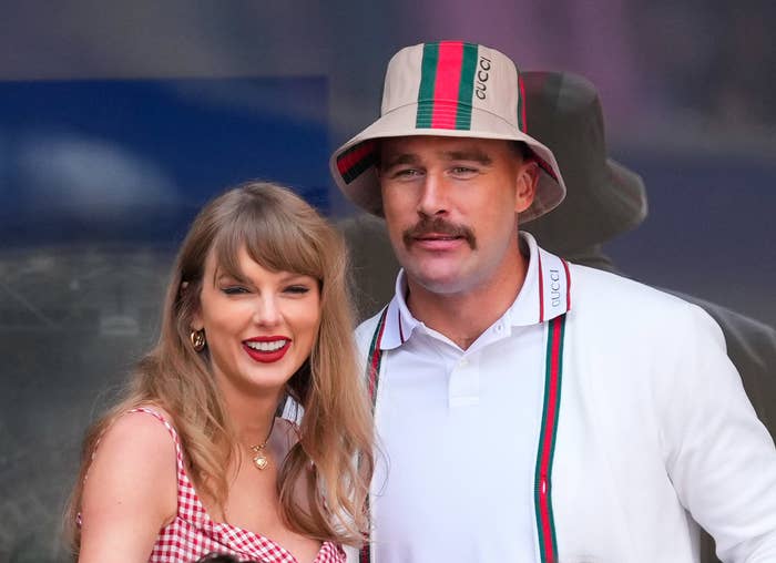 Taylor Swift in a red checkered dress and Travis Kelce in a white jacket and bucket hat