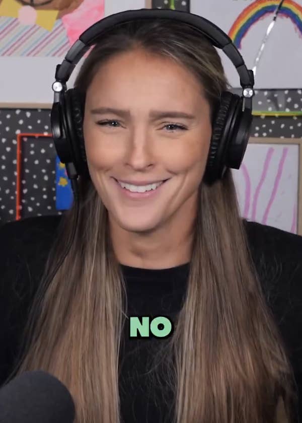Kylie Kelce wearing headphones, smiling, with art and crafts visible in the background