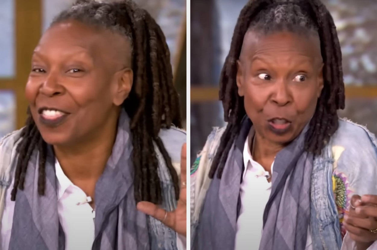 Celebrity in casual attire with a scarf, smiling and gesturing during a public appearance