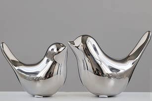 two silver bird figurines
