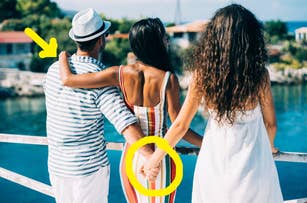 Three people by the water, two holding hands