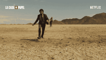 Scene from &quot;La Casa de Papel&quot;: two people running toward the camera in a desert landscape, mountains in the background. Netflix branding is visible