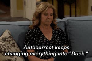 Person on a couch reacting to text: "Autocorrect keeps changing everything into 'Duck.'"