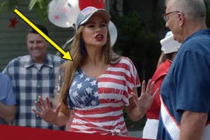 A person wearing a star-spangled shirt and cap interacts with people outside, suggesting an informal or community event setting