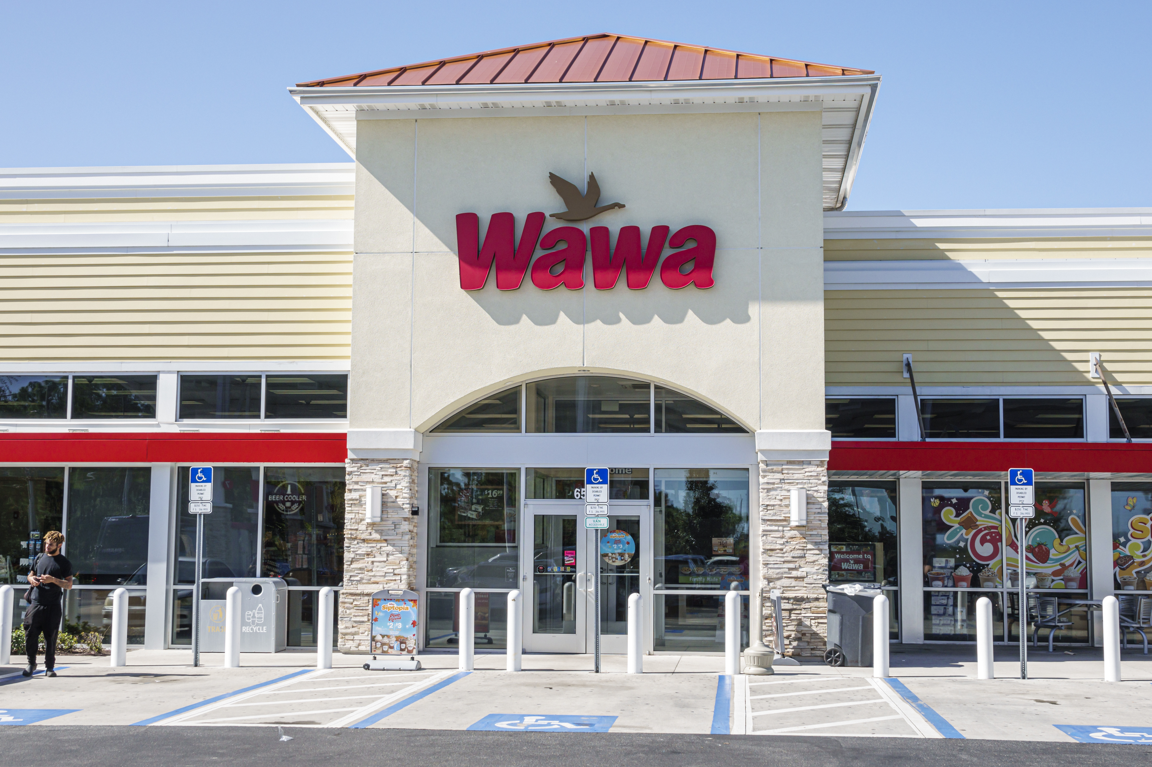 The exterior of a Wawa convenience store, featuring the main entrance and parking area