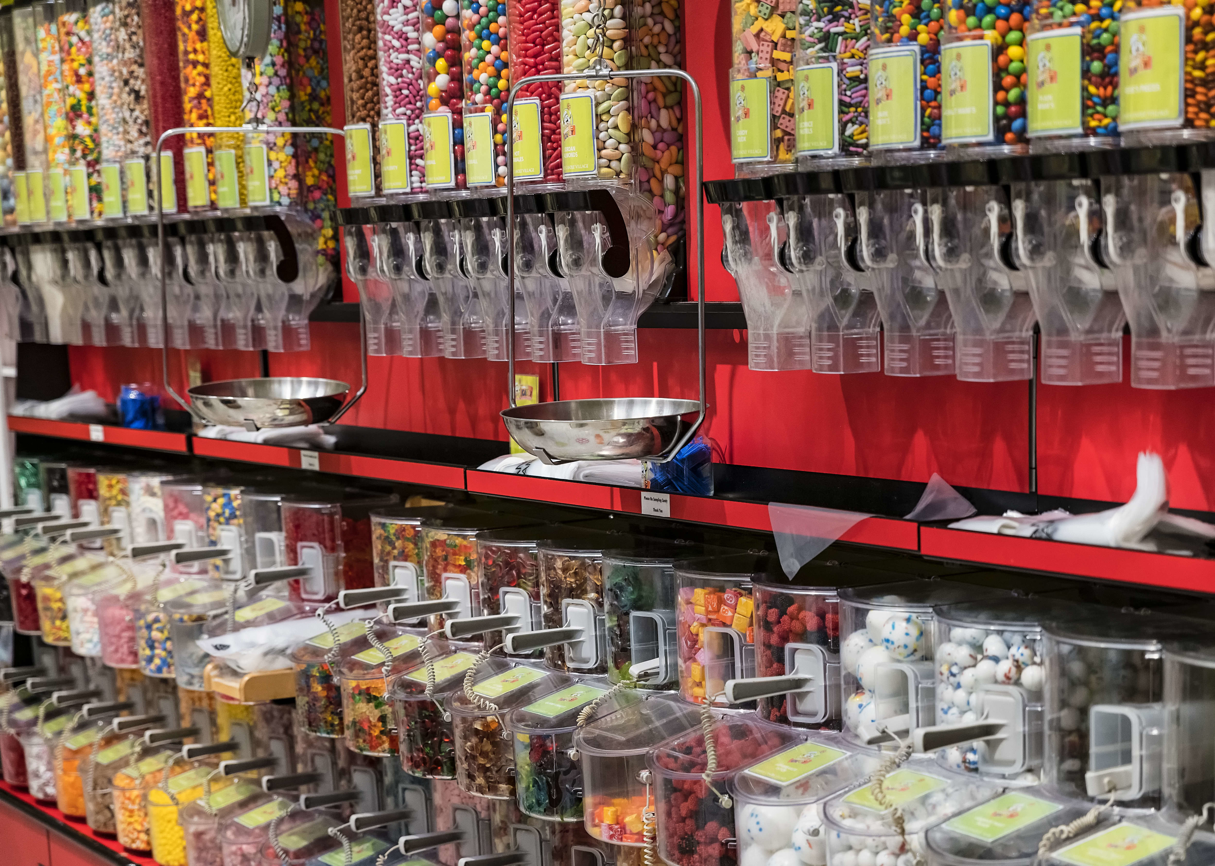 Bulk candy dispensers filled with assorted sweets in a store