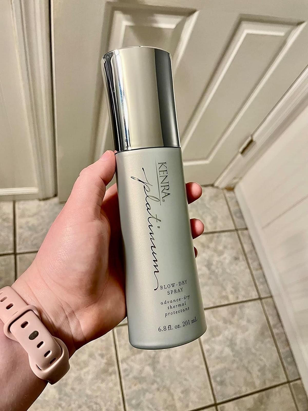 Reviewer holding the spray
