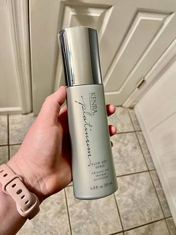 Reviewer holding the spray