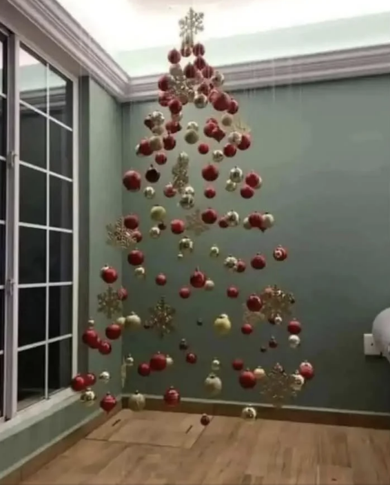 Floating festive ornaments arranged to form a suspended Christmas tree in a corner, creating a unique holiday display