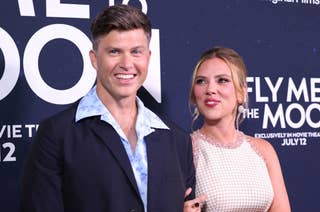 Colin Jost and Scarlett Johansson posing at an event