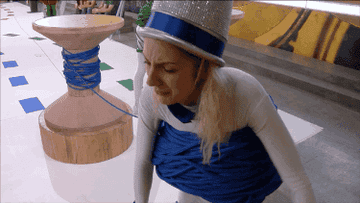 sarah appears dressed as a thimble wrapped in rope and struggles to unwind herself