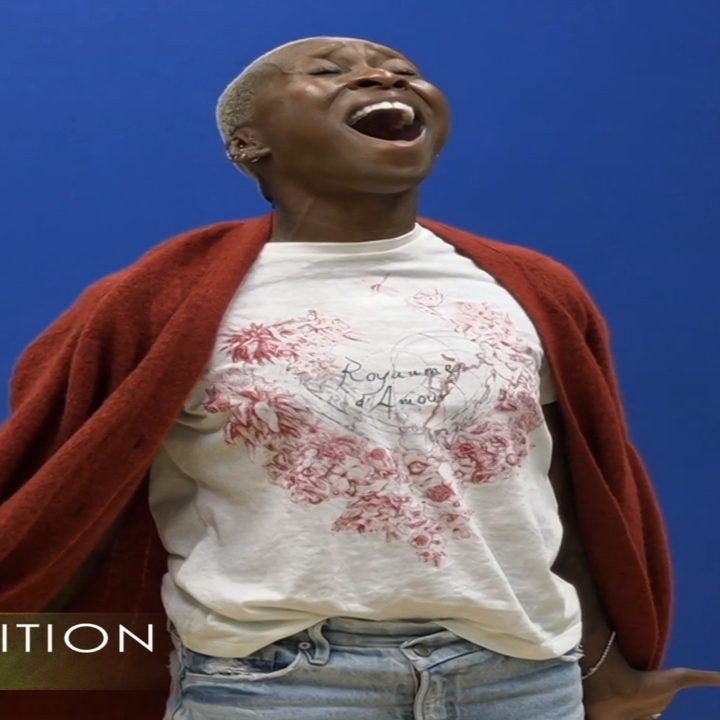 Person passionately singing in a casual t-shirt and jeans, with a red shawl. Text reads: "Cynthia's Audition, Summer 2021."