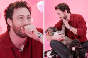 Aaron Taylor-Johnson in casual clothing smiles and plays with puppies, creating a joyful and heartwarming scene on a pink background