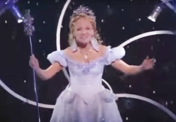 Kristin Chenoweth performing as Glinda with snow coming down around her on stage
