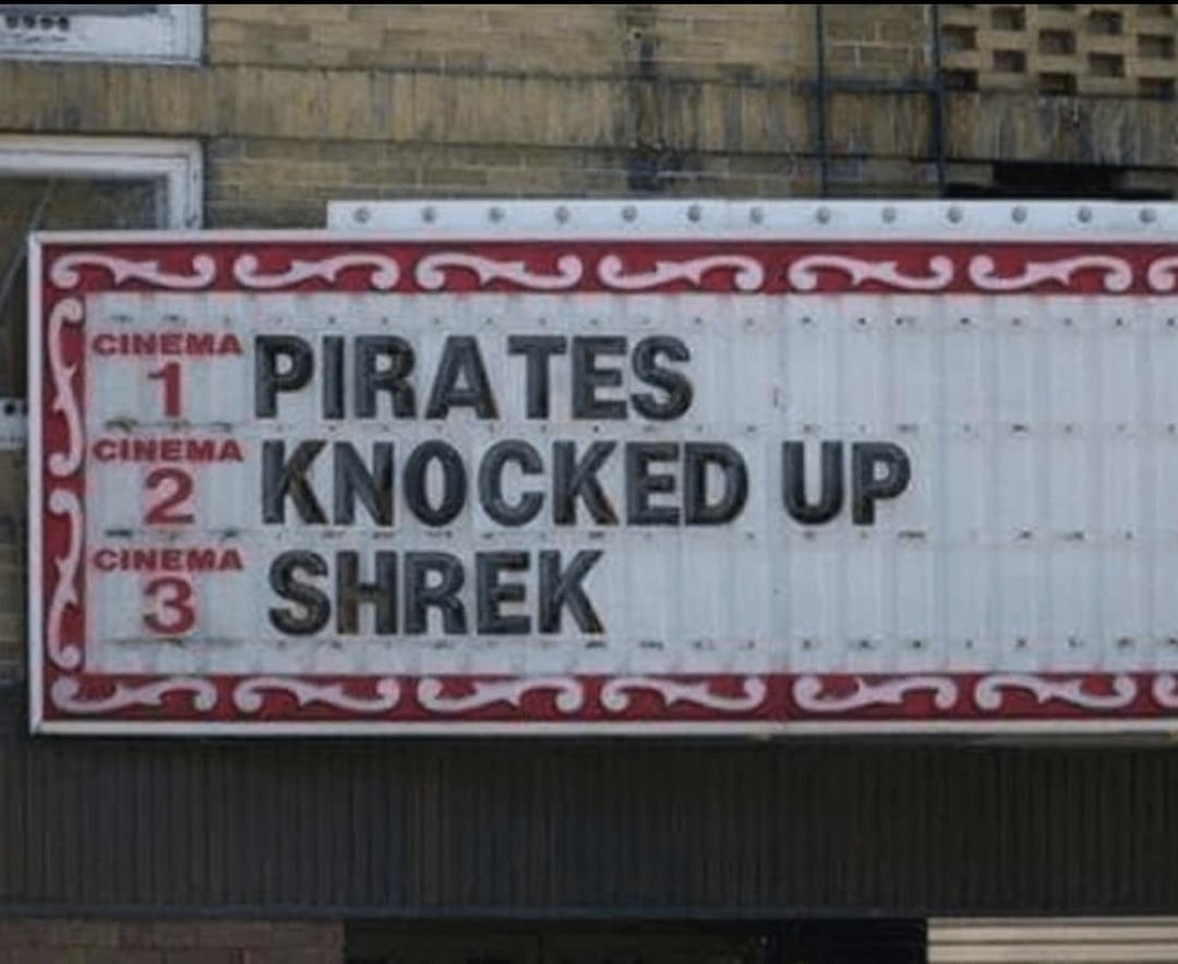 Movie theater marquee with three films listed: "Pirates," "Knocked Up," and "Shrek."
