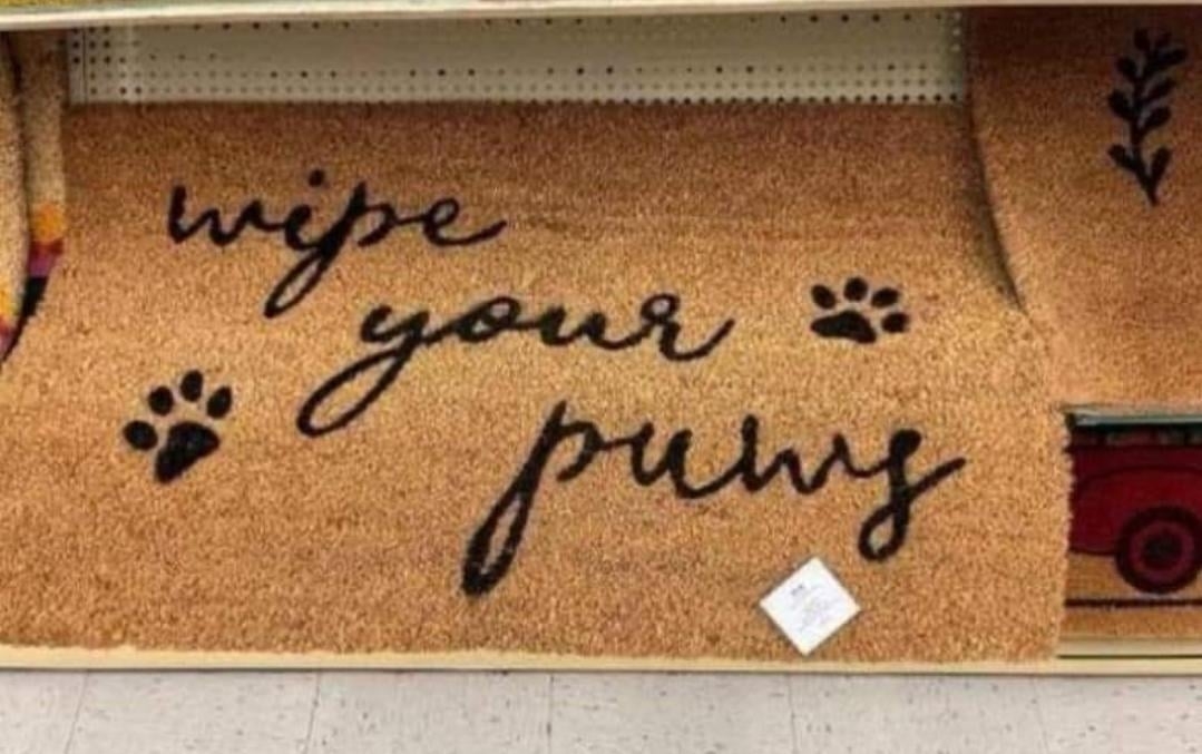 Doormat with text: "wipe your paws" and paw print designs