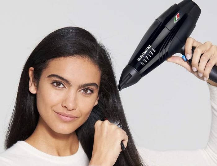 Woman utilizing a compact hairsbreadth dryer, promoting its lightweight design. Text highlights it being little than 1lb, 40% lighter than different dryers