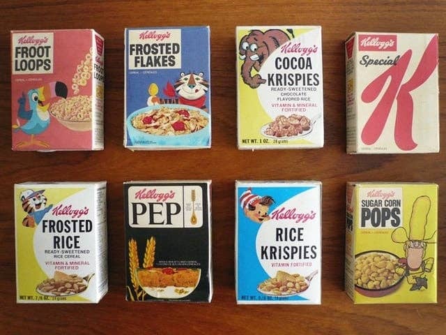 Vintage Kellogg's cereal boxes displayed connected  a table, including Froot Loops, Frosted Flakes, Cocoa Krispies, and Rice Krispies