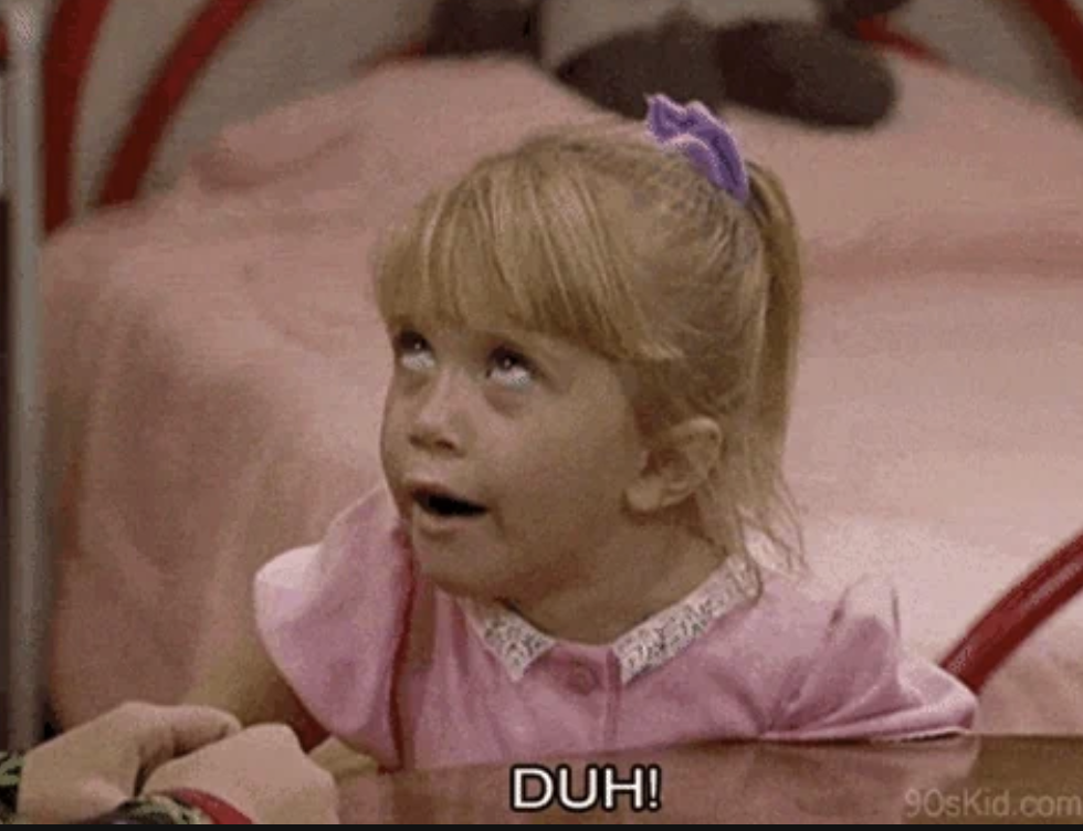 Child rolling eyes, wearing a short-sleeve dress with a white collar and a hair bow, saying "DUH!"