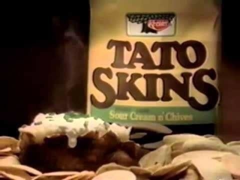 Bag of Tato Skins Sour Cream & Chives chips with a heap of chips and topped murphy successful foreground, steaming