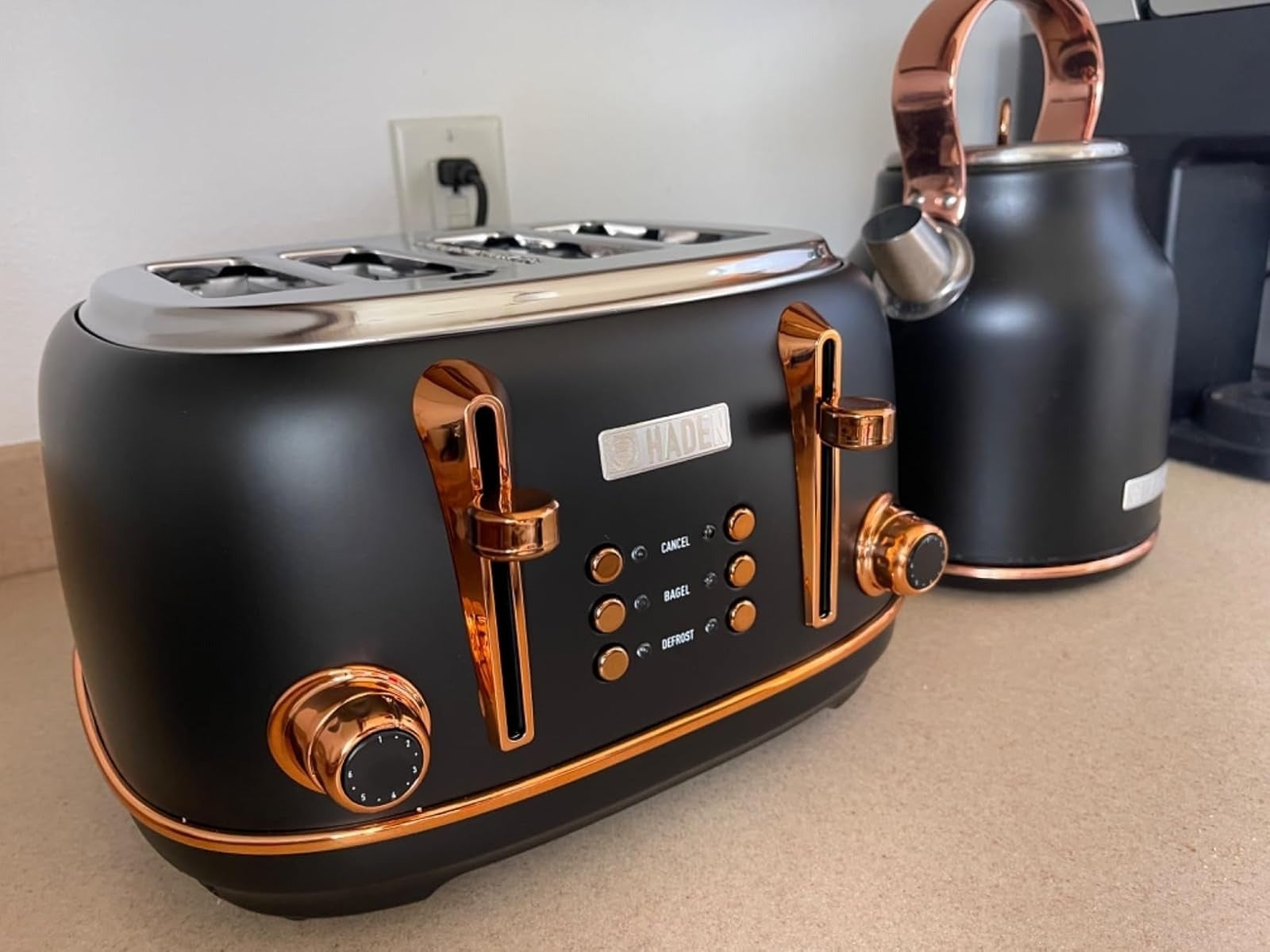 Sleek modern toaster and kettle set with metallic accents on a kitchen counter