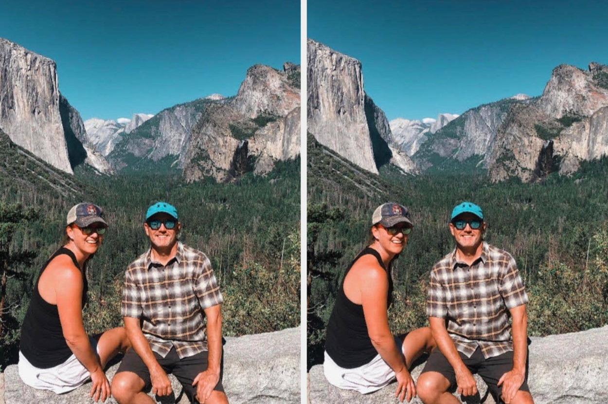 A couple smiles, seated outdoors with a scenic view of a mountain valley in the background. Both wear casual summer clothing and caps
